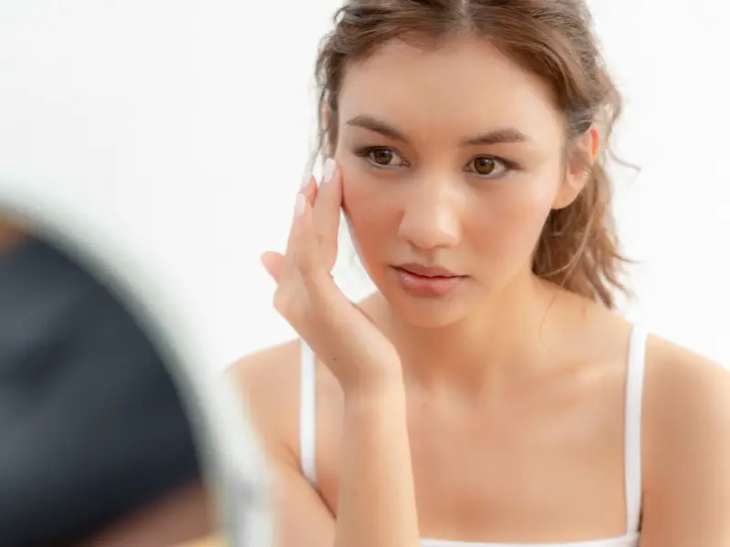 Woman applying retinol cream for sensitive skin