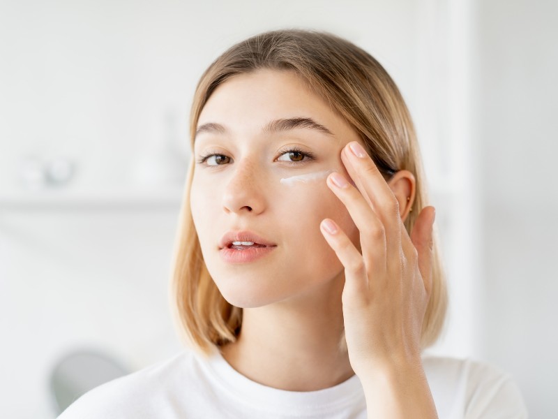 Woman applying hydrating retinol cream