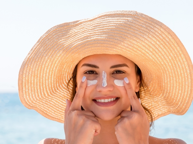 woman applying sunscreen in the morning