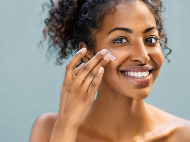 woman applying thick moisturizer before bed