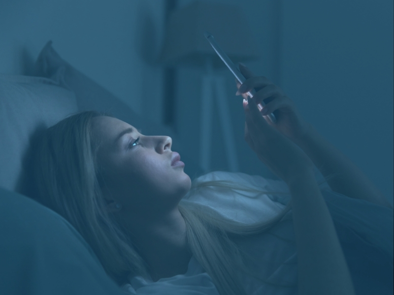 woman looking at phone screen with blue light filter