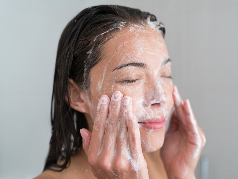 woman cleansing face in the morning