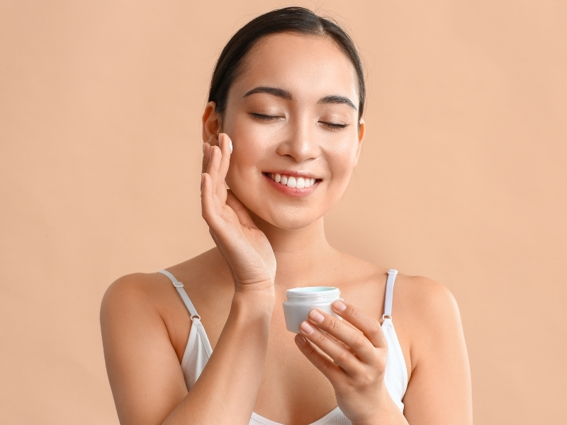 woman applying retinol cream for dark circles