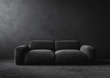 Charcoal gray fabric single sofa on a carpet in front of a textured dark gray wall, showcasing modern minimalist design elements and soft texture against a clean backdrop, high-resolution photography, product shot, hyper-realistic details.