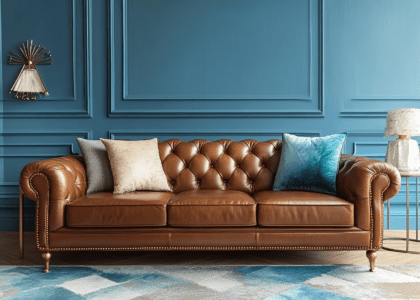 "Fashionable photography of a luxurious living room featuring a brown leather three-seater sofa with brass legs, diamond-shaped armrests, and decorative buttons, showcasing ultra-detailed realism and modern design elements in warm tones."