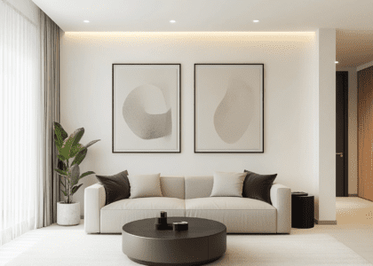 Modern living room with sleek furniture and minimalist decor featuring two abstract art prints in neutral tones, a round coffee table, and a potted plant, creating a cozy ambiance with soft lighting.