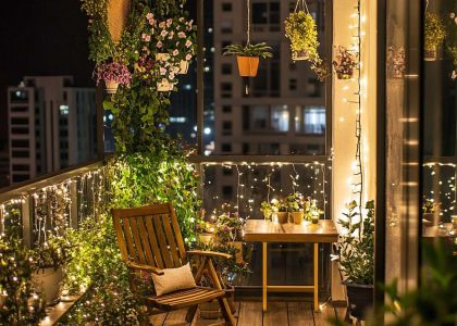 Modern balcony design featuring potted plants, cozy seating, and decorative lights, showcasing balcony garden ideas and stylish apartment decor for small spaces.