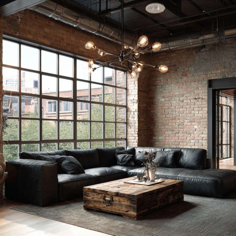 Modern industrial living room with sunlight streaming through large metal-framed windows, exposed brick walls, a low-profile black leather sofa, rustic wood coffee table, and an Edison bulb chandelier hanging from exposed ductwork, creating an inviting urban chic ambiance.